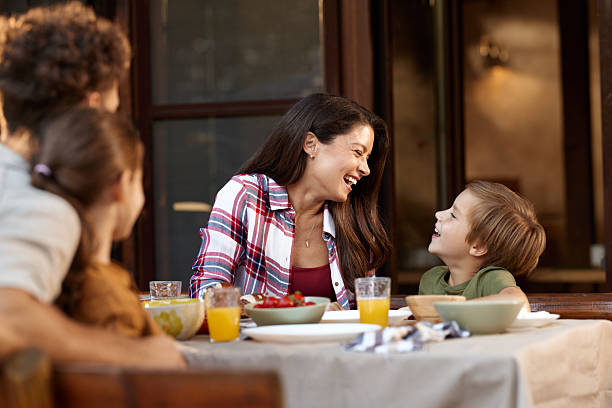 istock Happy mother talking to her son during a meal at the table. 2214620284