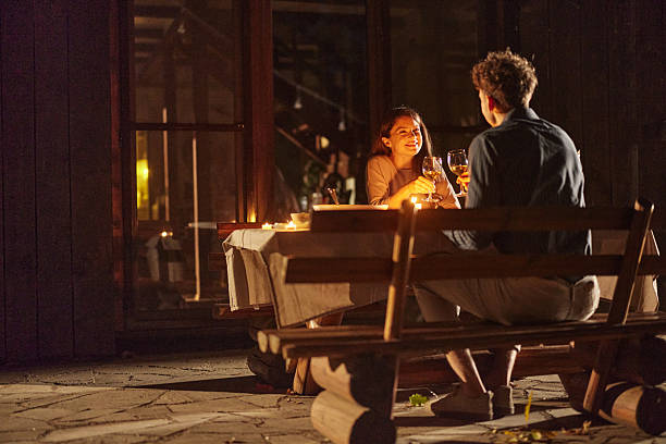 istock Happy woman toasting with her husband during dinner on a patio. 2214620680