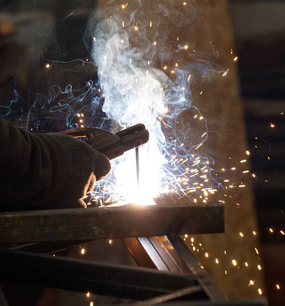istock A man is welding metal with a bright orange light and sparks flying 2214623534