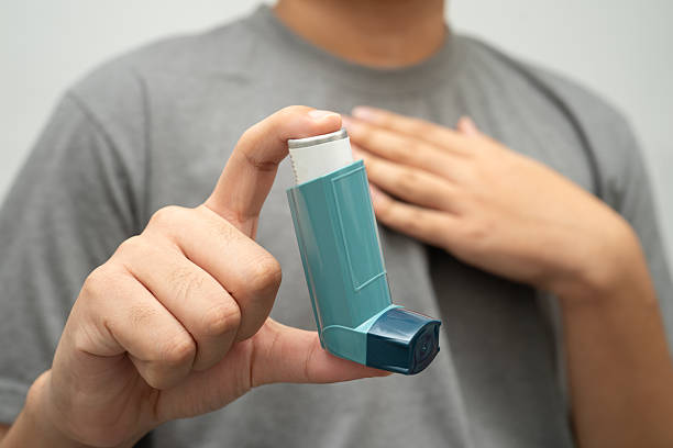 istock Asthma and chronic obstructive pulmonary disease COPD, Asian young man using metered dose inhaler MDI. 2214626441