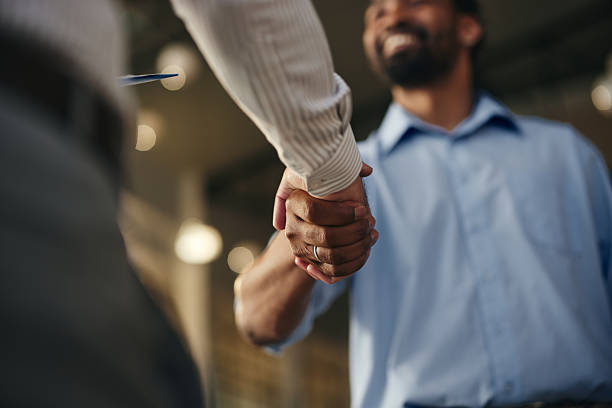 Close up of unrecognizable African American businessman came to a successful agreement in the office.