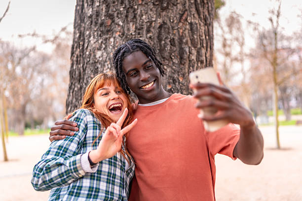 istock Cheerful young couple taking a selfie in the park 2214628598