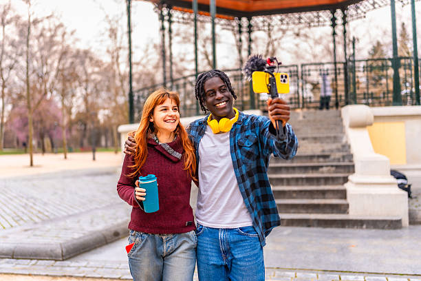 istock Two young content creators filming in a park 2214628602