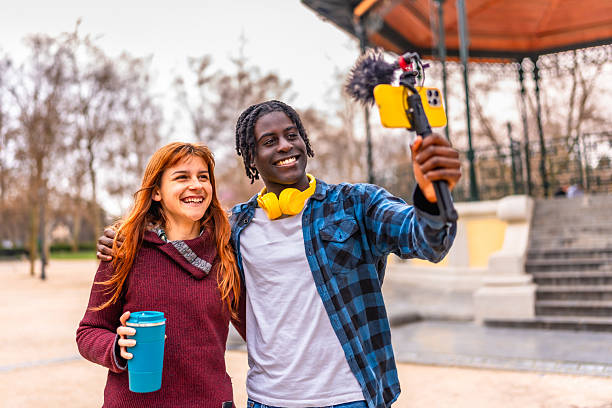 istock Young bloggers creating content in a park 2214628606