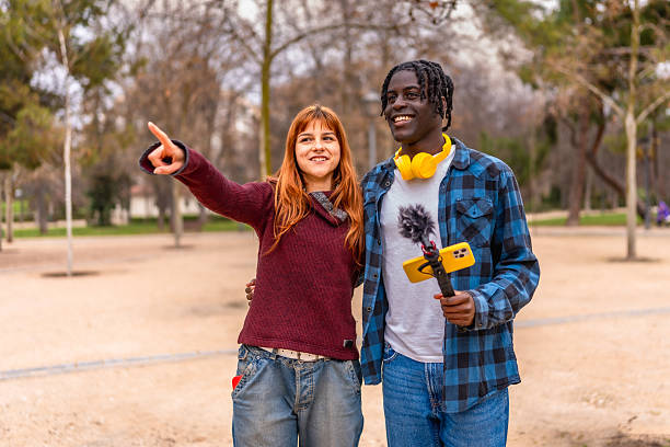 istock Young filmmakers shooting a video in a park using a smartphone and microphone 2214628614