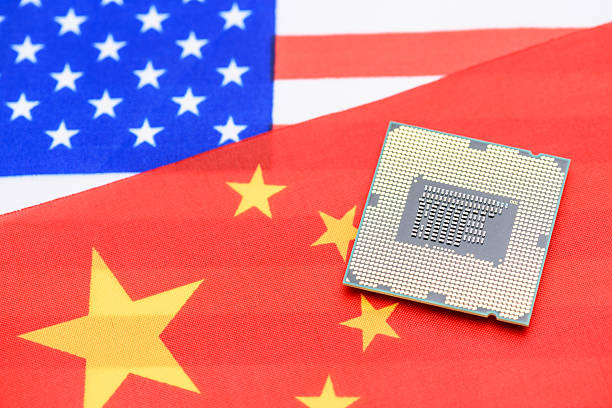istock Tech warfare: A microchip on the U.S. and China flags symbolizes the escalating technological rivalry, reflecting their strategic competition in semiconductor innovation, and supply chain dominance. 2214628793