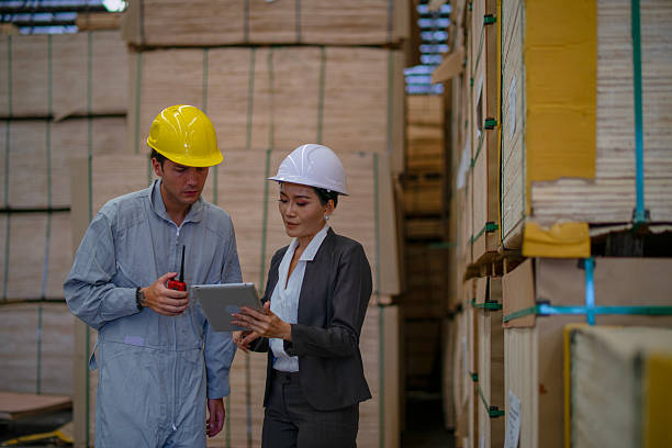 istock Blue collar workers  are working at wood factory. 2214632568