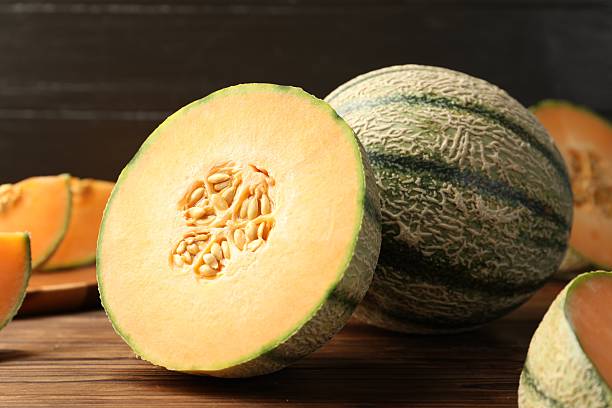 istock Cut Cantaloupe melon on wooden table, closeup 2214637169