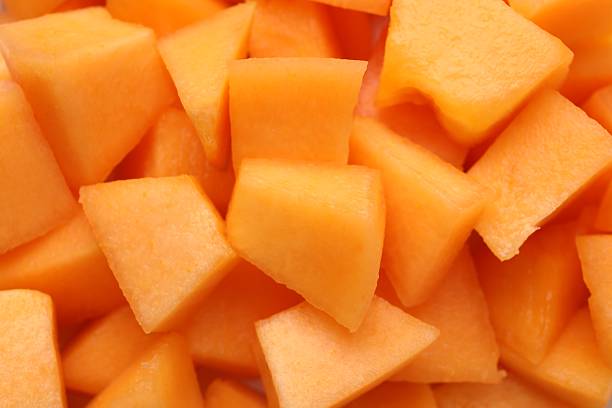 istock Pieces of Cantaloupe melon as background, top view 2214637225