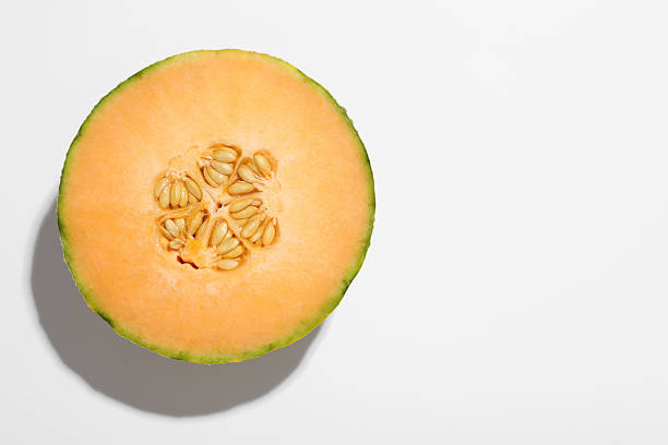 istock Half of fresh Cantaloupe melon on white table, top view. Space for text 2214637291