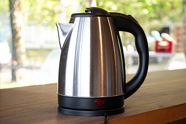 istock Electric steel kettle stands on the table outside 2214639896