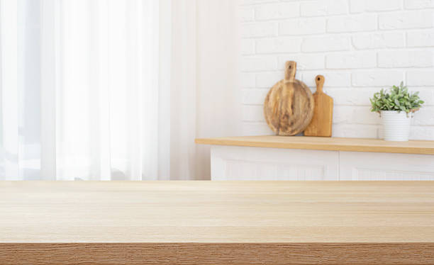 istock Kitchen table counter top for product presentation on blurred house interior background 2214640573
