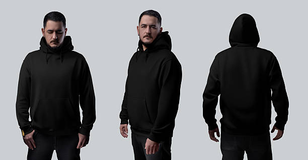 istock Mockup of a black oversized hoodie on a bearded man, front, side, back view, isolated on a studio background. Set 2214640595
