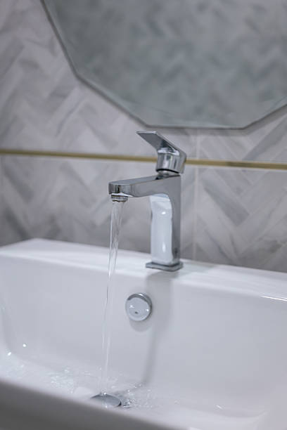 istock Clean water is flowing from luxury design shiny faucet. 2214640972