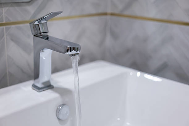istock Clean water is flowing from luxury design shiny faucet. 2214640975
