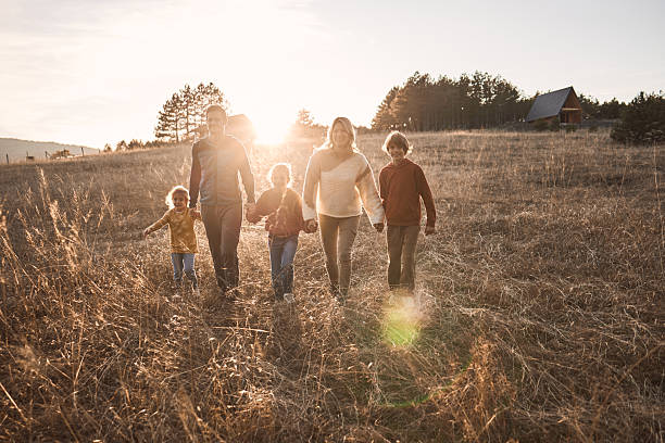 istock Happy family in nature on sunset 2214641532