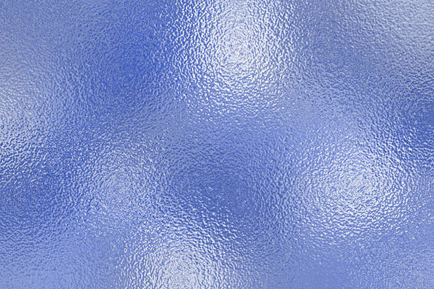 istock Shiny silver foil texture. Soft blue foil glass texture background. Abstract gradient bright light reflection and shiny rough texture surface. Glass effect background 2214641656