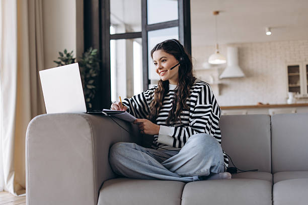 istock Happy young teenager getting new knowledge using laptop and headset during online education 2214641685