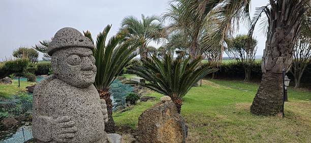 This serene garden scene blends cultural heritage and tropical greenery, unique to Jeju’s landscape.