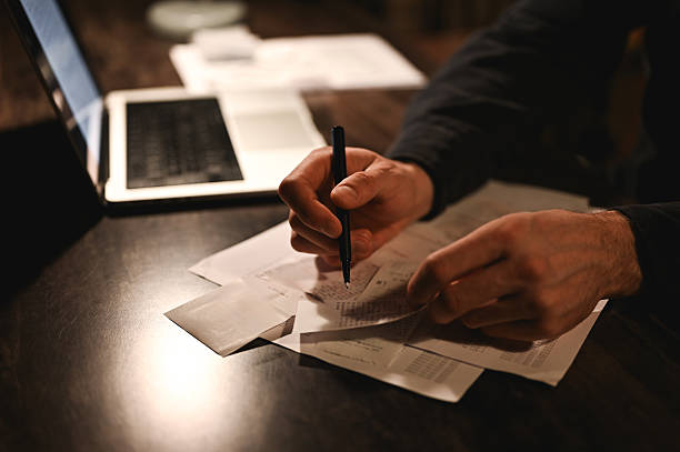 Businessman working late at night on financial documents