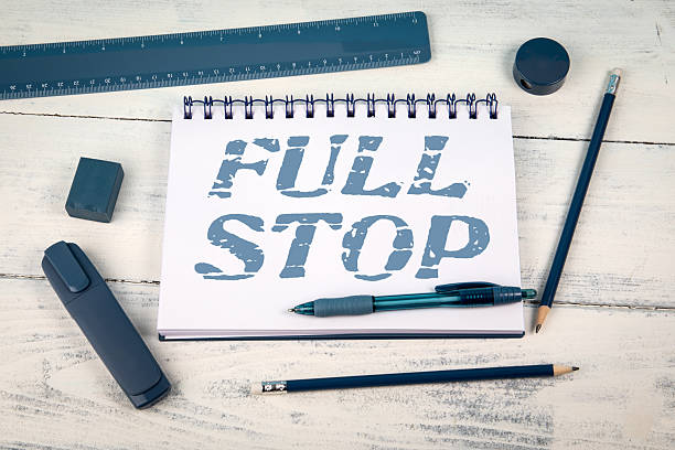 istock Full Stop Phrase Written on Notepad with Blue Stationery on White Wooden Background 2214644987