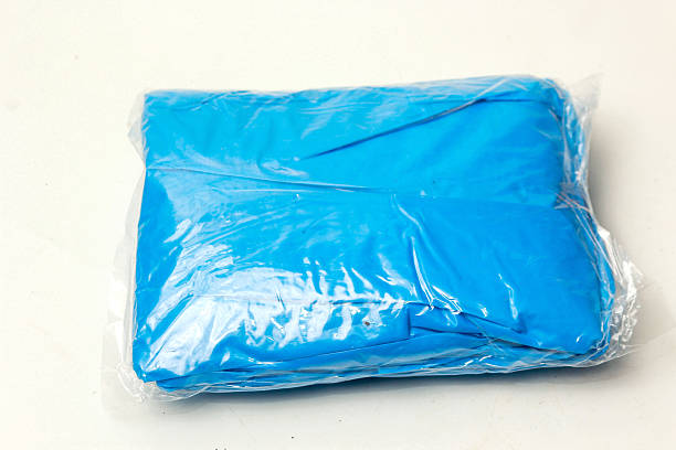 istock Plastic raincoat that is folded in small package isolated on white background 2214647194