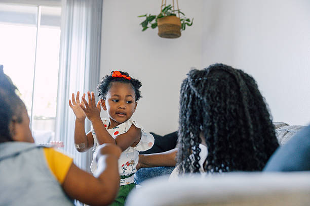 istock Single mother playing with her two daughters at home 2214647226