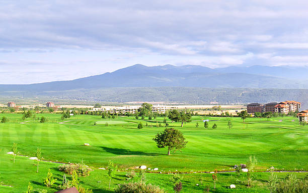 istock A green field with a golf course in the background 2214647495