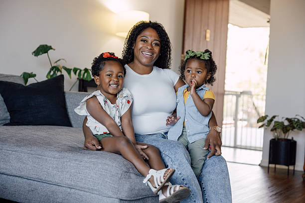 istock Single mother playing with her two daughters at home 2214647544
