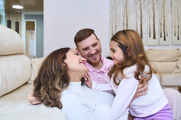 istock Happy family sharing a tender moment of affection on sofa 2214649735