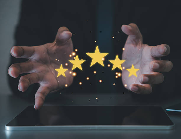 istock Close-up of a client's hand holding five stars 2214650484