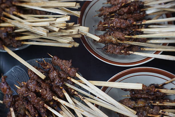 istock multiple Sate (satay) skewers served on plates close-up. m 2214650945