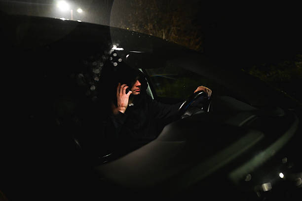 istock Businessman talking on phone while driving car at night 2214651297