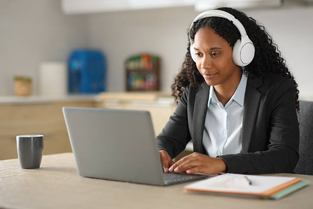 istock Black executive tele working in the kitchen at home 2214653648
