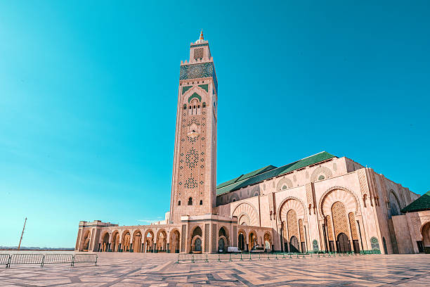 istock Hassan II Mosque with its minaret towering over the paved square under the vibrant blue sky in Casablanca, Morocco 2214655843