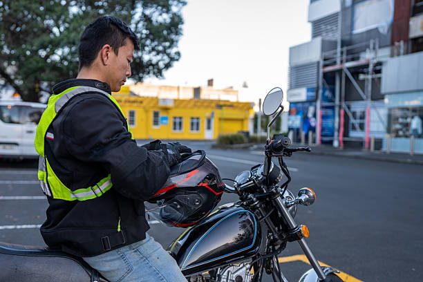 istock Asian Male Adjusting his Motorcycle Helmet 2214657798