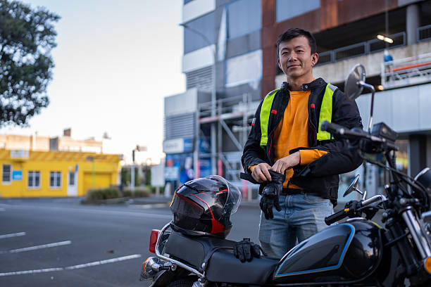 istock Confident Man Standing Next to Motorcycle in City 2214657851