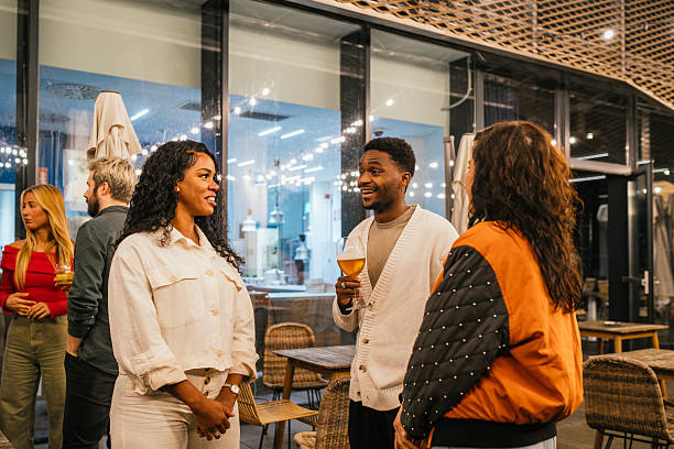 istock Friends enjoying drinks and conversation at a multiethnic party 2214659077