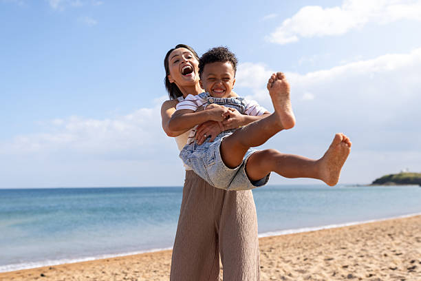 istock Happy Mother and Son at the Beach 2214666950