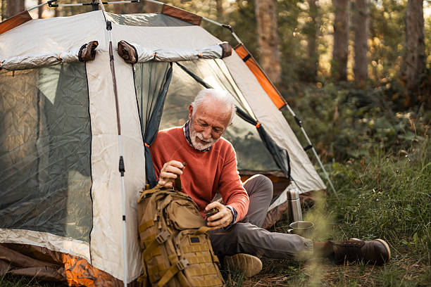 istock Senior Man Enjoying Solo Camping in a Forest Setting 2214668843