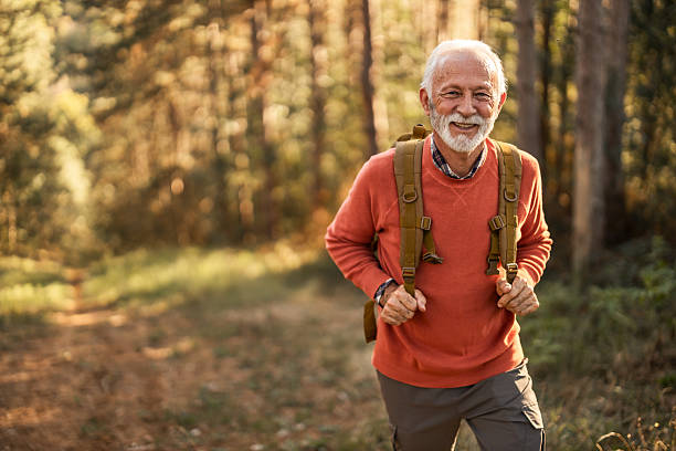 istock Senior Man Enjoying Hiking Adventure In A Serene Forest Setting 2214669014