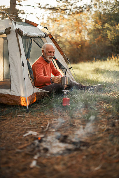 istock Senior Man Enjoying Camping in Nature with Tea 2214669475