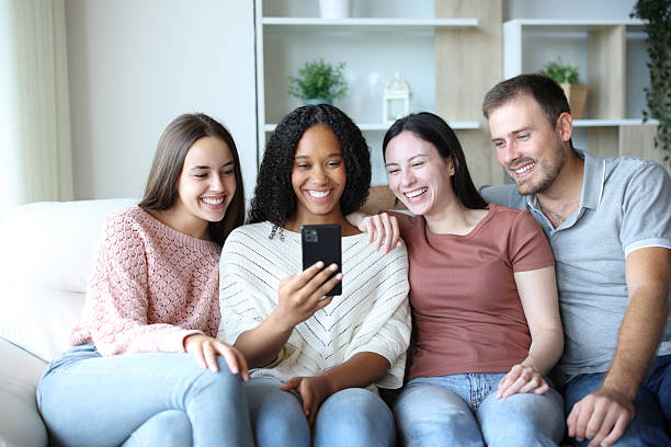 istock Four interracial friends at home checking mobile phone 2214671327