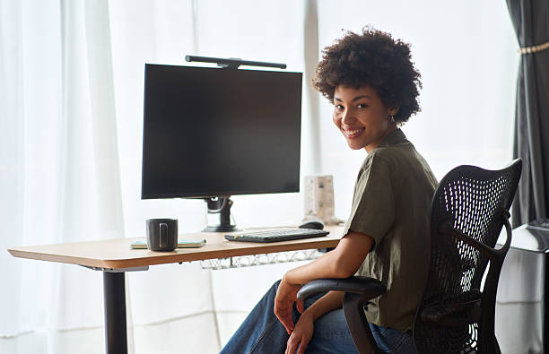 istock Young happy African girl student sitting at work desk with computer, portrait. 2214671372