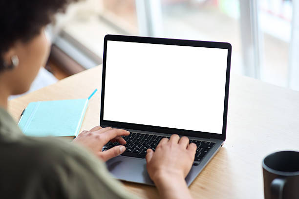 istock Over shoulder view of African woman elearning using laptop mock up screen. 2214671409