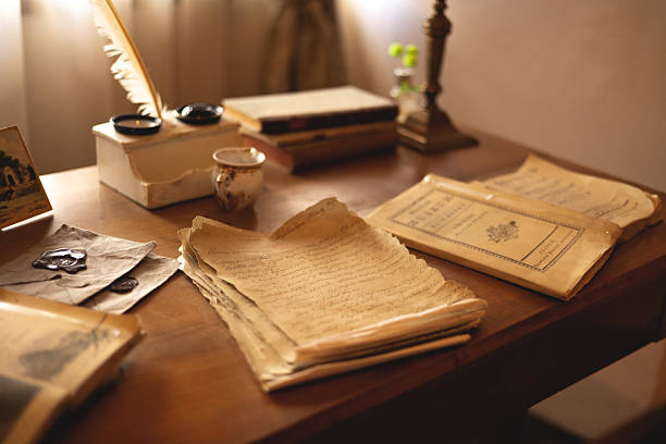 istock Vintage manuscripts and inkwell on the table 2214673310