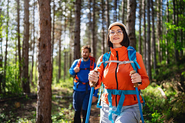 istock Active couple enjoying a sunny day hiking in the forest 2214676850