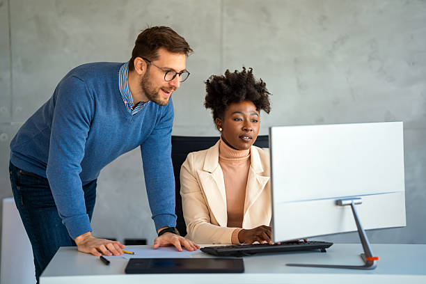 istock Happy businesspeople laughing while collaborating on a new project in an office. 2214676933