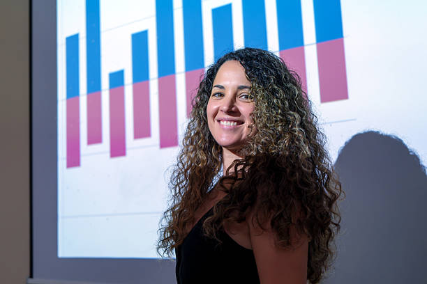 istock Young businesswoman smiling while presenting positive data charts 2214677185