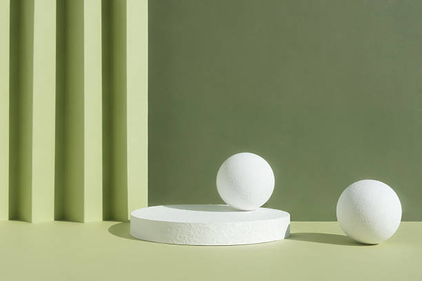 istock White round podium on an abstract green background. A scene with a geometric backdrop. Showcase, display case for the product presentation. 2214677236